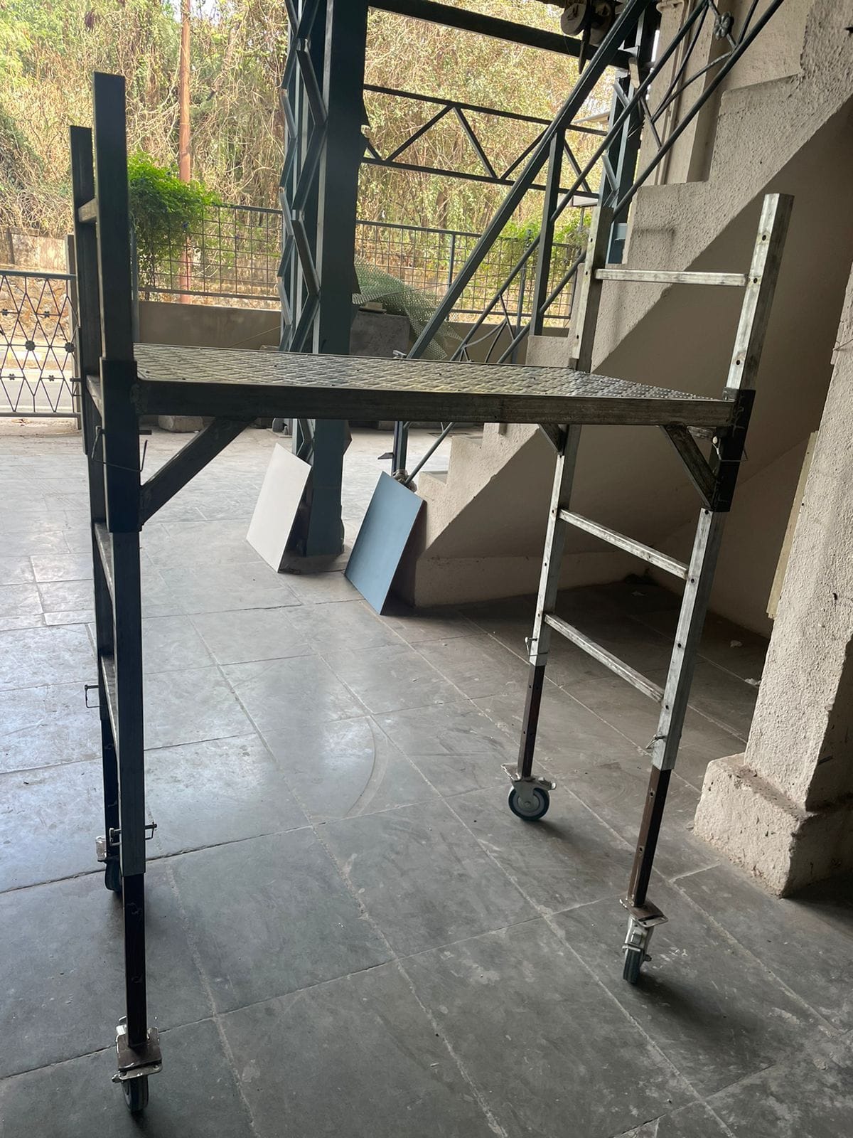 Metal scaffolding beside tall windows